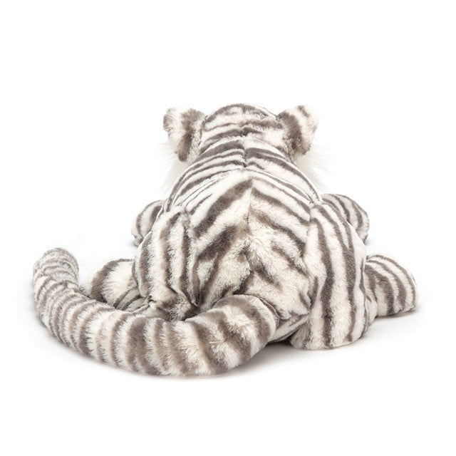 A plush white tiger toy with gray stripes is shown from the back, sitting.