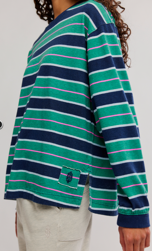 Striped long-sleeve shirt in navy and green with pink accents.