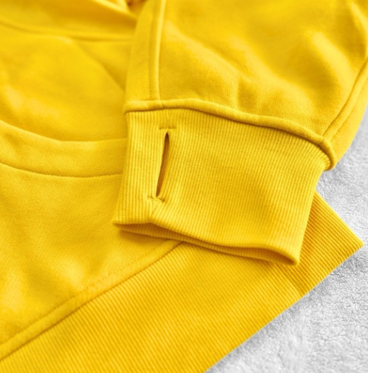 Yellow oversized half-zip hoodie with thumbholes.