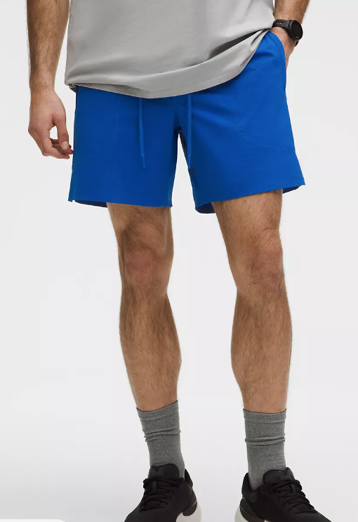 Men's blue athletic shorts with a drawstring waist and zippered pockets.