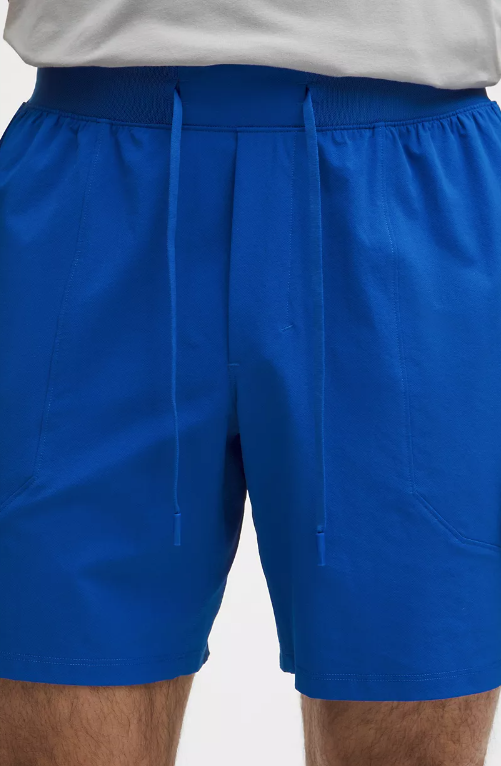 Blue athletic shorts with a drawstring waist and zippered pockets.
