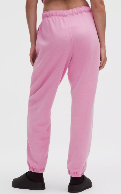 Pink oversized fleece joggers with elastic cuffs and waistband.