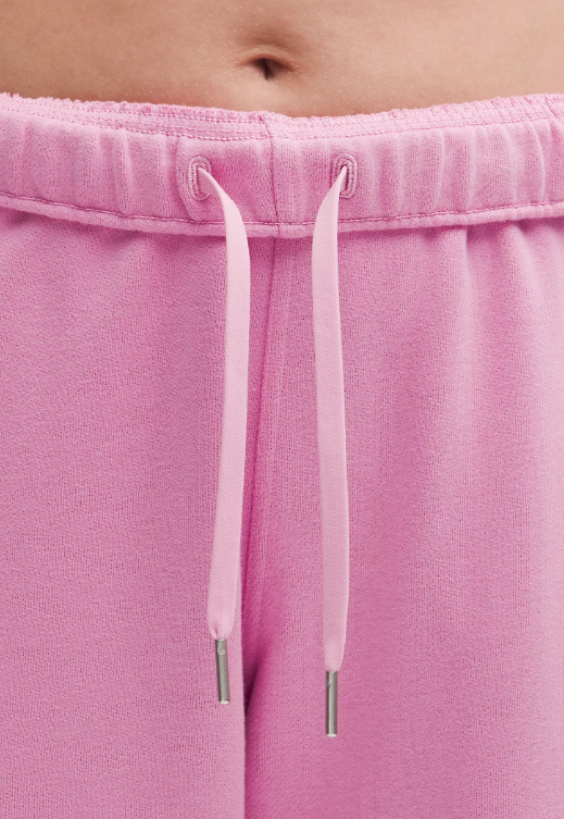 Pink joggers with a drawstring waist and silver-tipped cords.