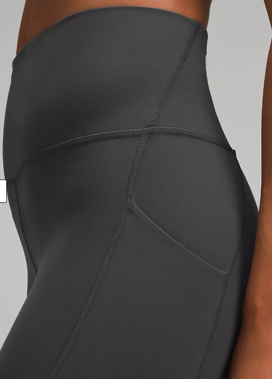 Close-up of graphite grey high-rise leggings with side pockets.