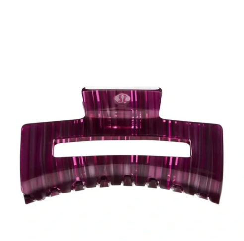 Extra large claw hair clip in berry rumble and racer pink with a striped pattern.