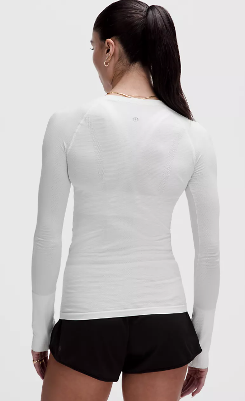 White seamless long-sleeve top with thumbholes.
