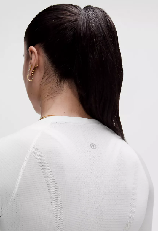 White Swiftly Long Sleeve 2.0 top with a subtle logo on the back.