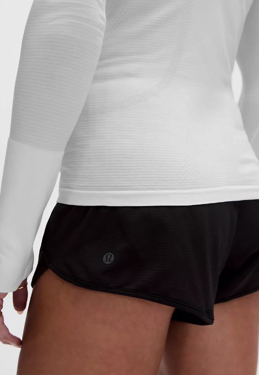 White seamless long sleeve top with thumbholes.