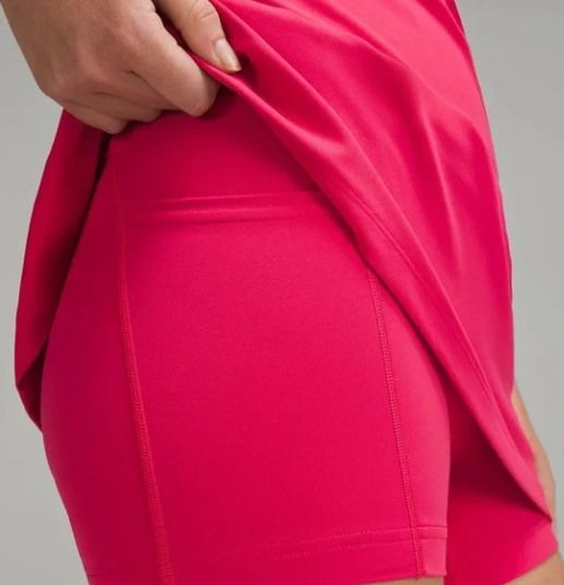 Close-up of a pink dress with built-in shorts and a pocket.