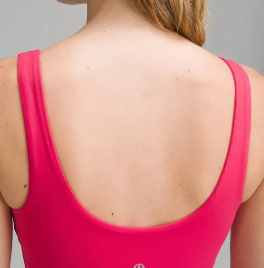 Back view of a woman wearing a bright pink dress.