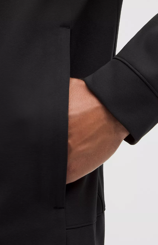 Black Sojourn jacket with a hand in the pocket.