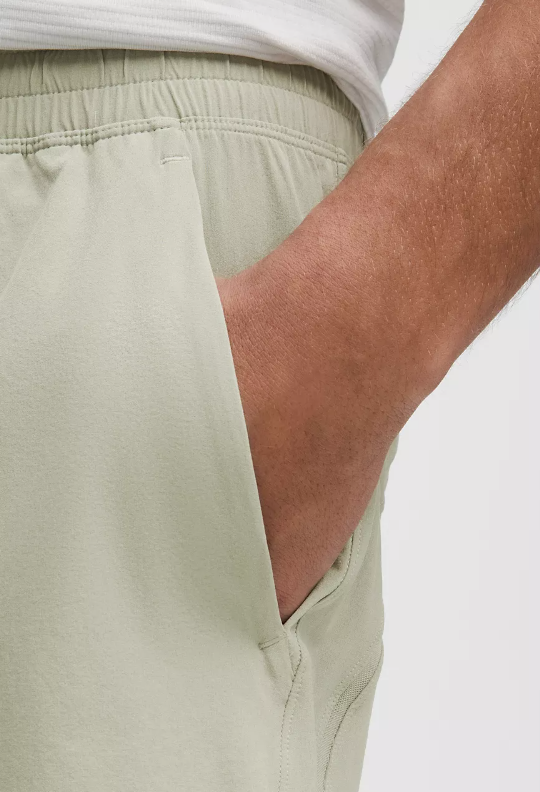 Light green linerless shorts with a hand in the pocket.