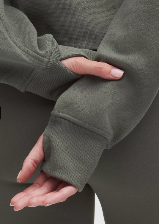 Oversized grey half-zip hoodie with thumbholes.