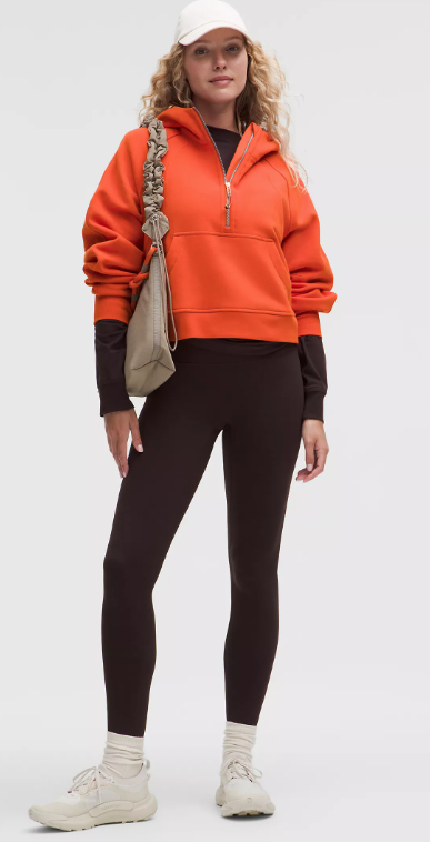 Oversized orange half-zip hoodie with a relaxed fit.