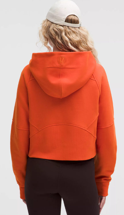 Back view of an orange Scuba Oversized Half Zip Hoodie with a white baseball cap.