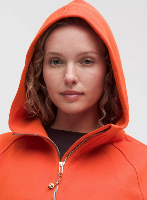 Oversized orange half-zip hoodie with a relaxed fit.