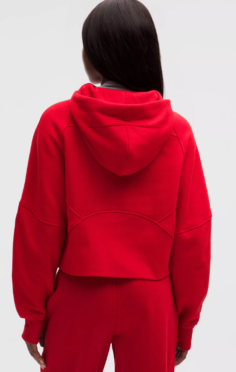 Back view of a woman wearing a red oversized Scuba Half-Zip Hoodie.
