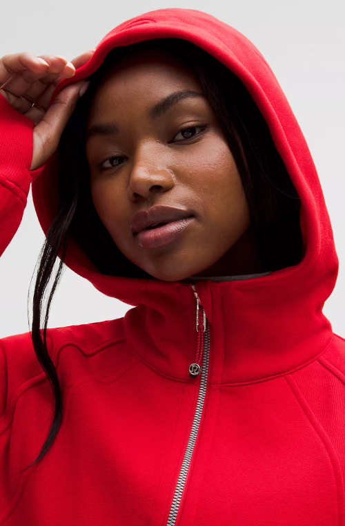 A woman wears a red Scuba Oversized Half-Zip Hoodie.