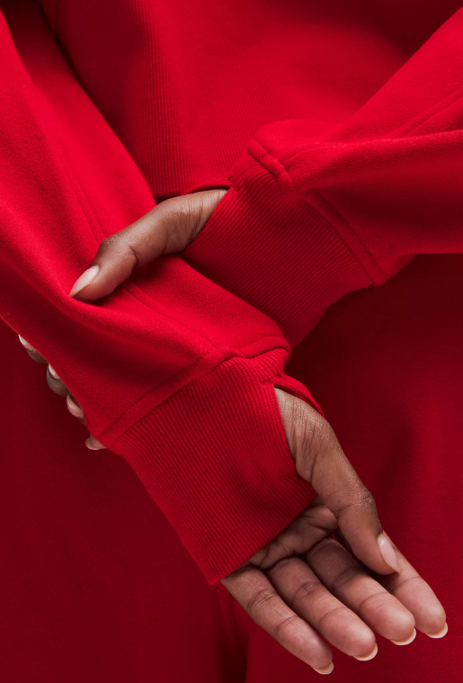 Red oversized half-zip hoodie with thumbholes.