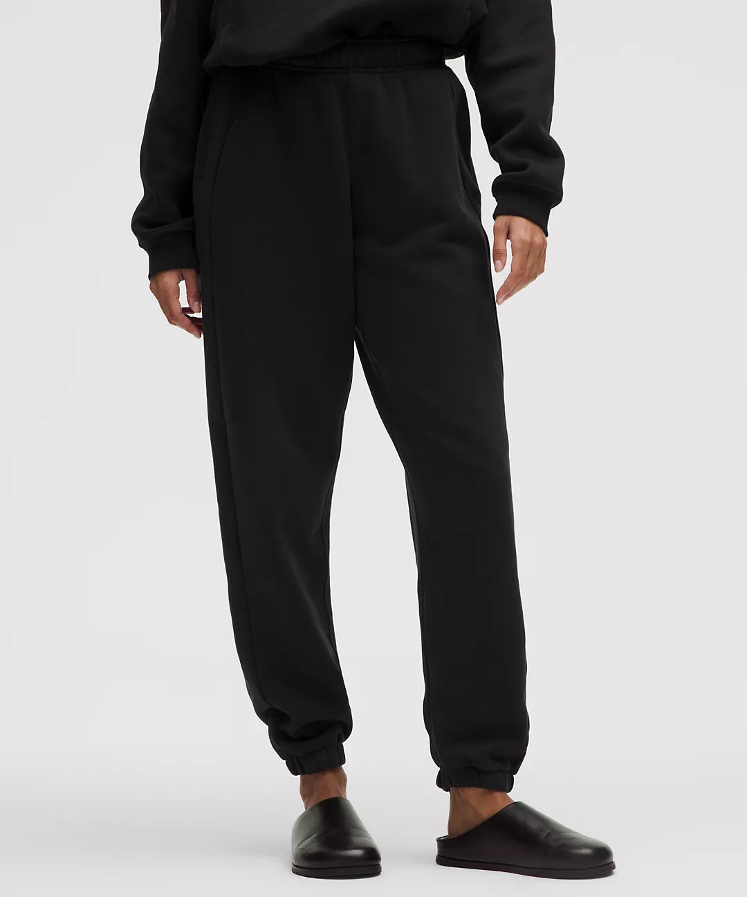 Black mid-rise oversized joggers with cuffed ankles.