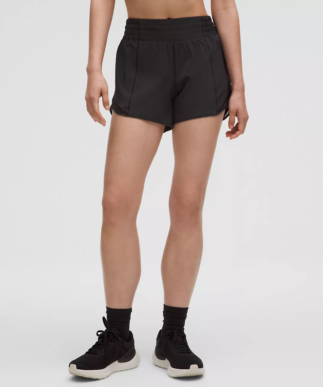 Black high-rise lined shorts with a 4-inch inseam.