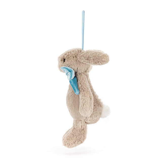A plush beige bunny ornament with a blue carrot hanging from a light blue string.