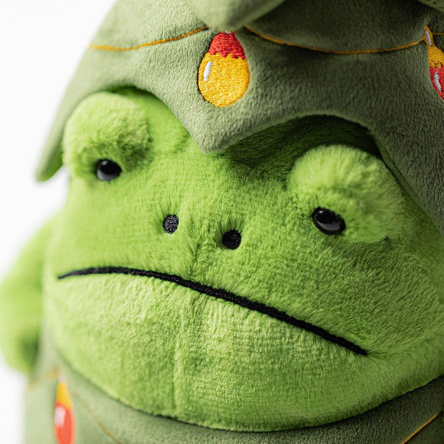 A plush green frog wearing a Christmas tree costume with embroidered baubles.