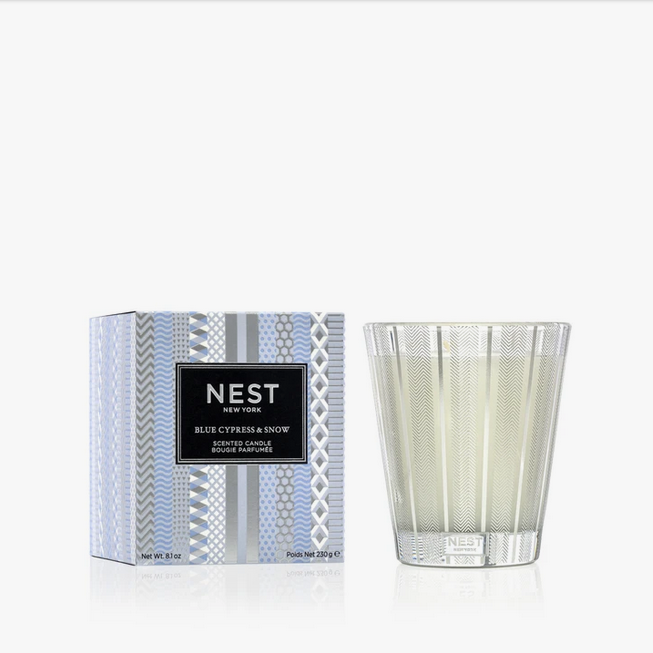 Blue Cypress & Snow Classic Candle in a striped glass vessel next to its patterned box.