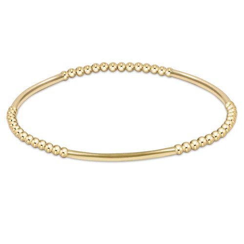A gold bead bracelet with a smooth bar section.