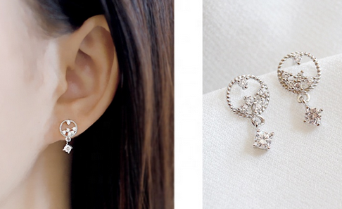 Platinum-plated sterling silver stud earrings with a circular design and dangling cubic zirconia.