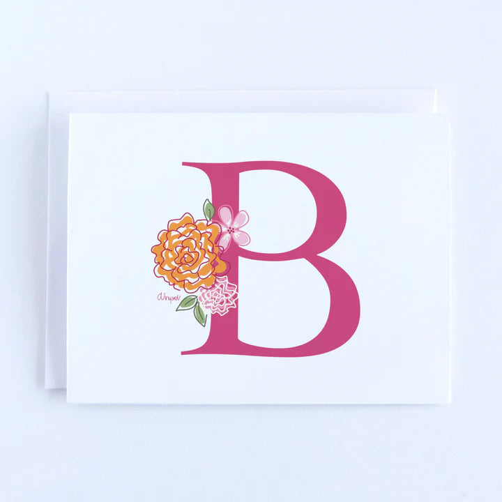 A pink letter B with orange and pink flowers on a white folded notecard.