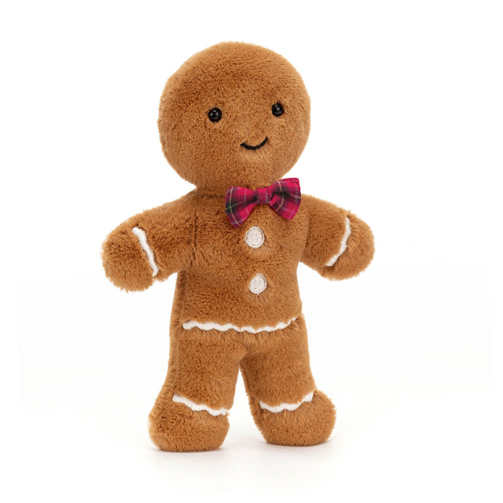 A plush gingerbread man toy with a red tartan bow tie and white icing details.