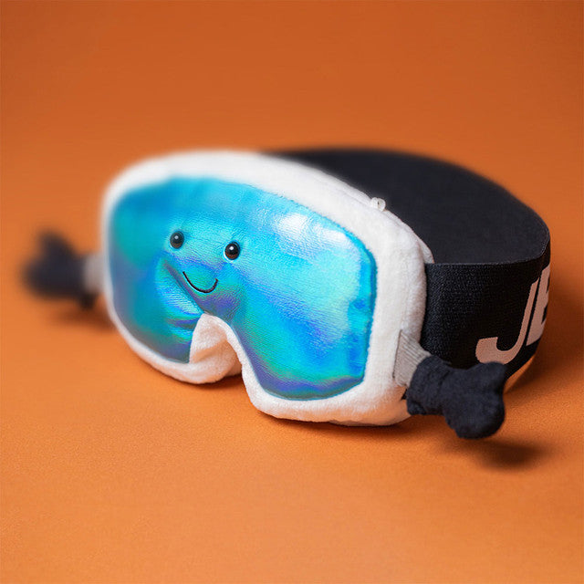 Plush ski goggles with a blue iridescent lens and a smiling face.