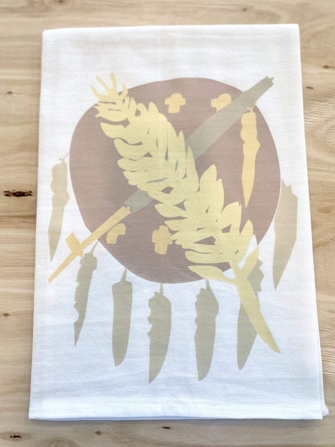 Neutral Oklahoma Flag Tea Towel with a brown circle, wheat, and feathers.