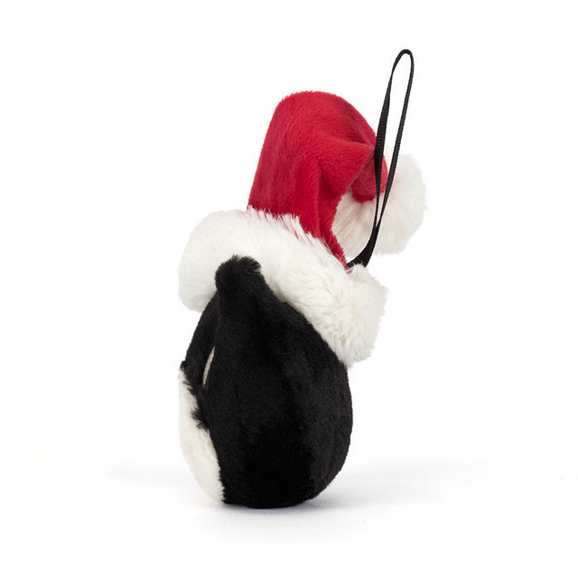 A black plush ornament with a white belly and a red Santa hat with white trim.