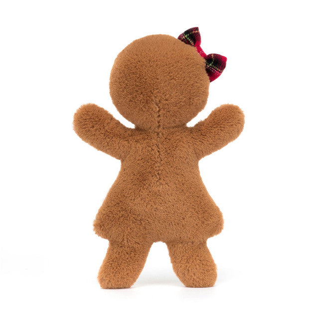 A plush gingerbread doll with a red and green plaid bow, viewed from the back.