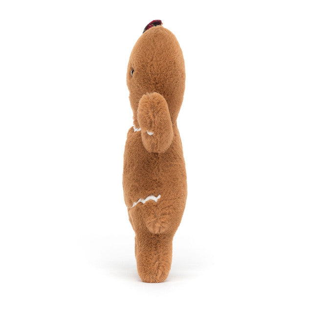 A brown gingerbread plush toy with white icing details and a tartan bow.