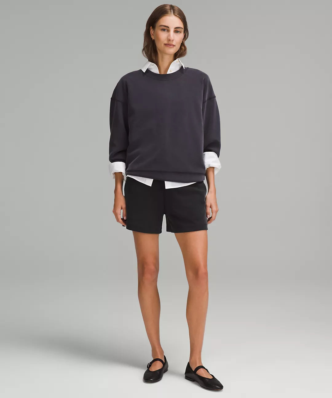 Woman wearing black Softstreme high-rise 4-inch shorts.