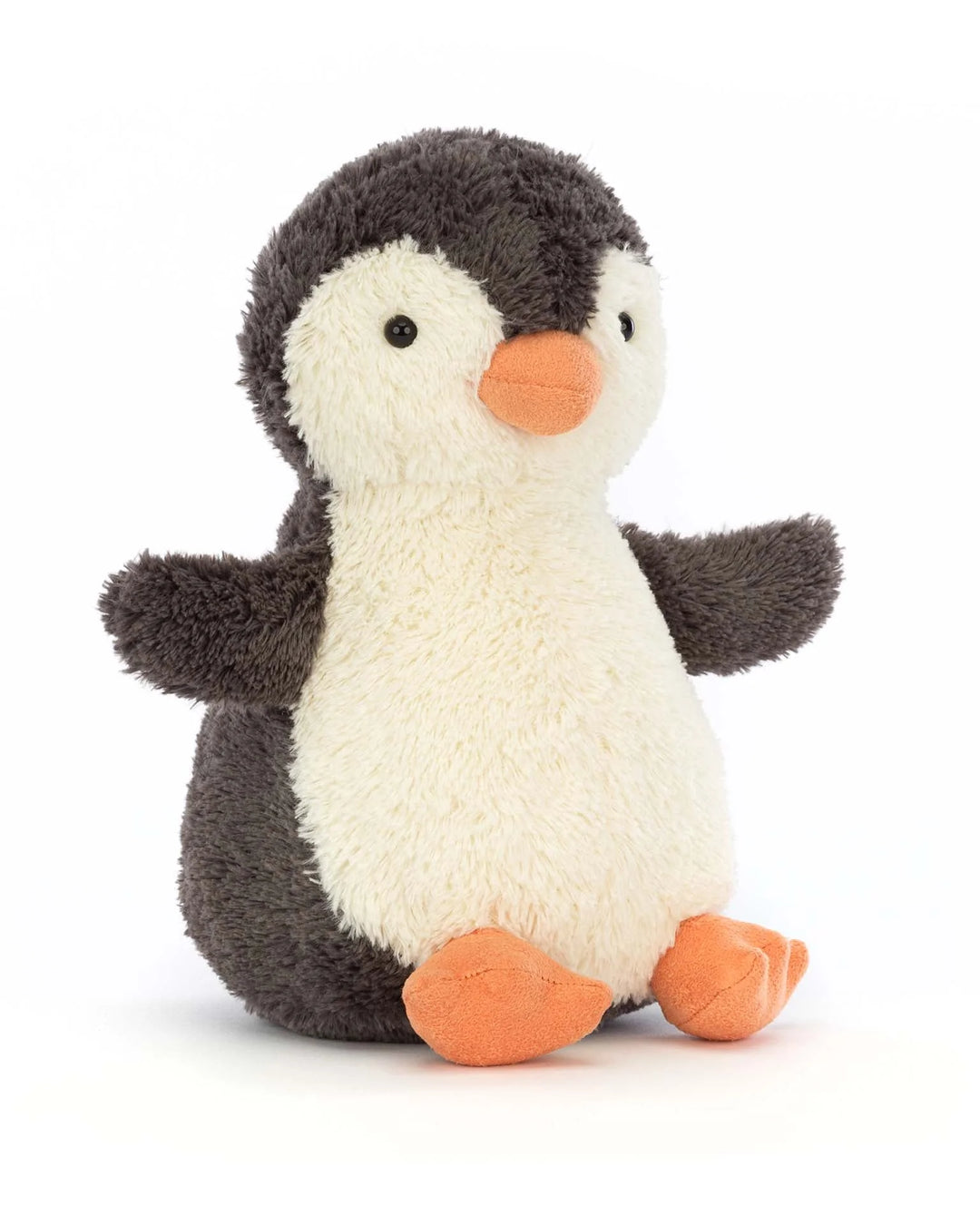 A plush toy penguin with a white belly, gray back, orange beak, and feet.