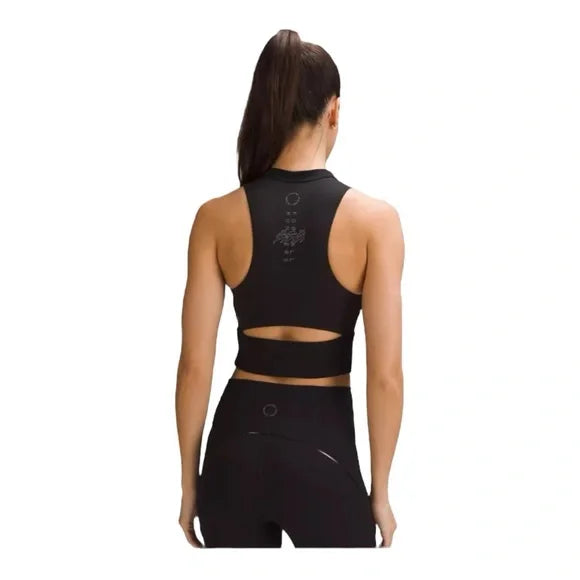 Black Nulux cropped half-zip track tank top with a cutout detail.