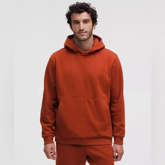 Men's orange cotton-blend fleece hoodie with a relaxed fit and kangaroo pocket.