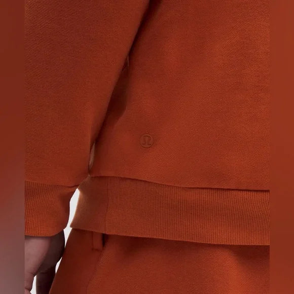 Orange Steady State Hoodie with a subtle logo detail.