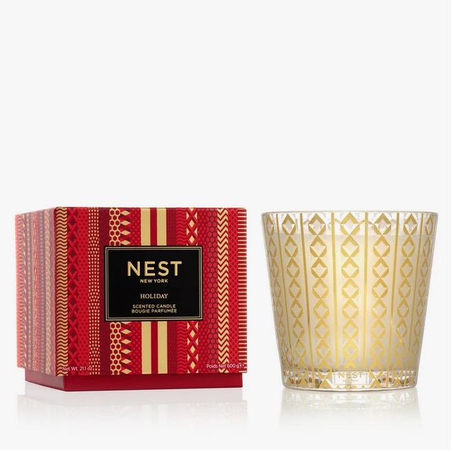 A Nest New York Holiday 3-wick candle in a red and gold patterned box and glass vessel.