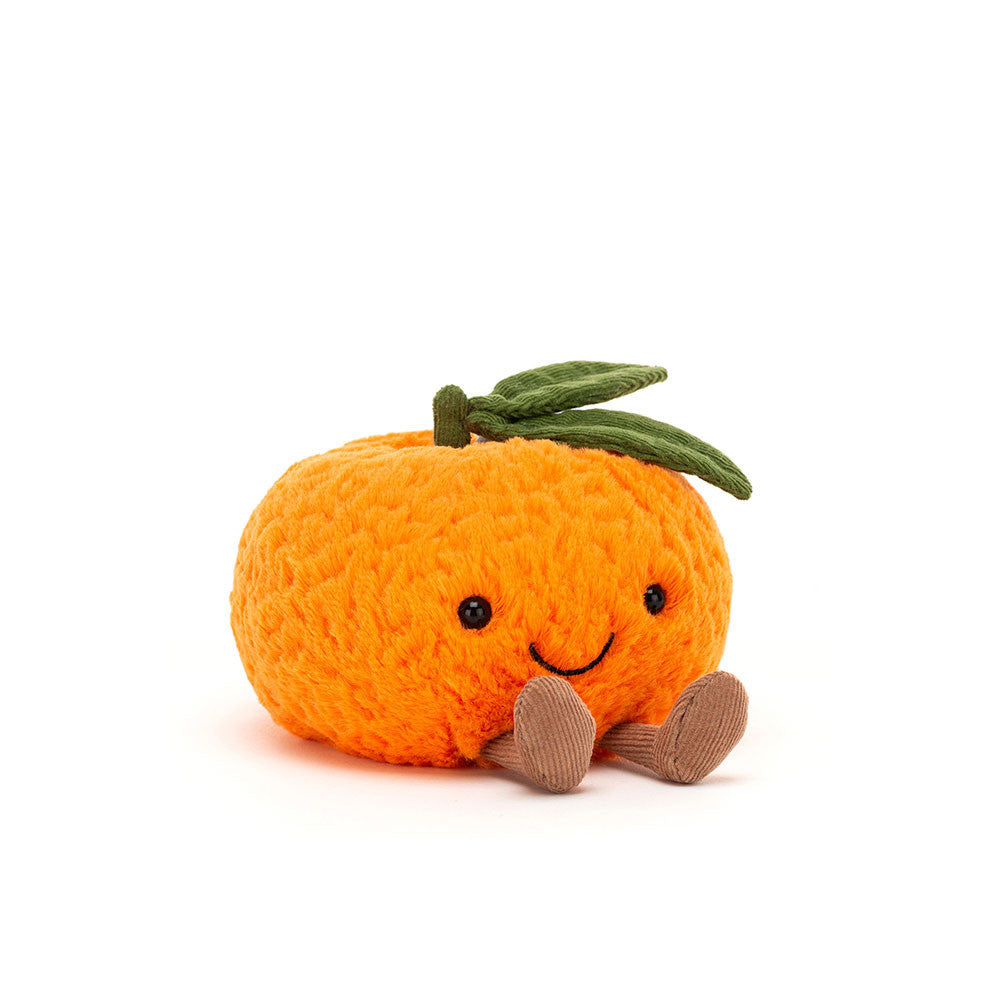 A plush orange clementine toy with a green stem and leaves, black eyes, and a stitched smile.