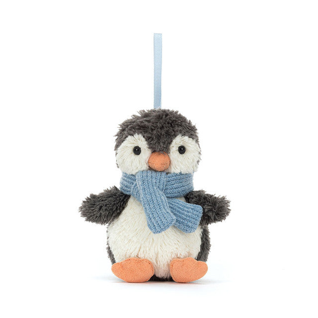 A fluffy gray and white penguin ornament with an orange beak and feet, wearing a blue scarf.