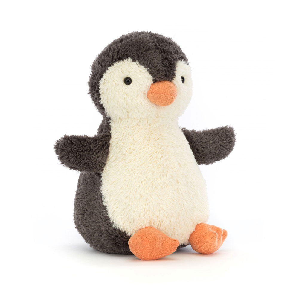A small, plush penguin toy with dark gray and cream fur, orange beak, and feet.