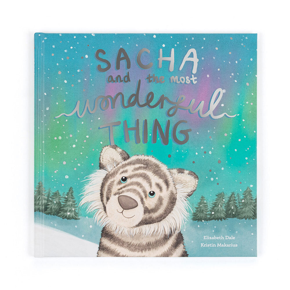 A children's book cover features a white tiger cub in a snowy landscape with the title "Sacha and the Most Wonderful Thing."