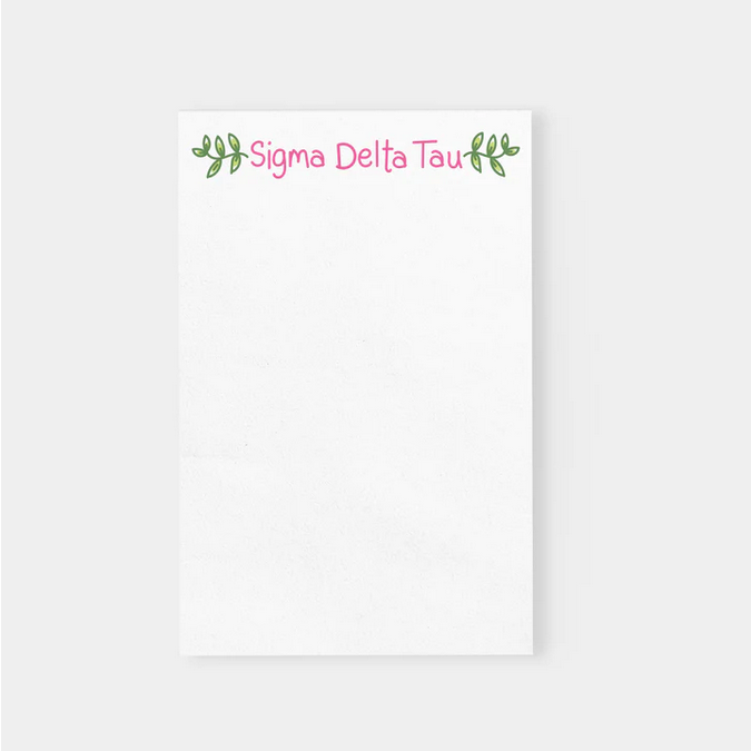 White notepad with "Sigma Delta Tau" in pink script and green leaf accents.