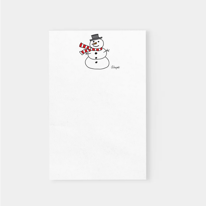 A white notepad features a hand-drawn snowman wearing a black hat and red and white striped scarf.