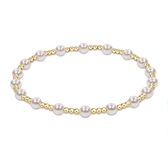A bracelet with alternating white pearls and small gold beads.